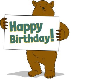 Cartoon-Bär mit Happy Birthday-Schild